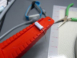 (Image: Using special tool to bend resistor leads with correct spacing)