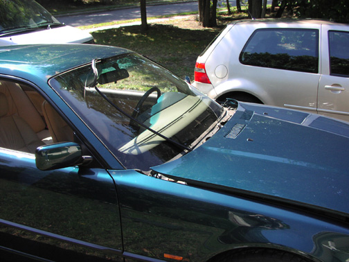 (Image: Hood moved forward and windshield trim partially removed)
