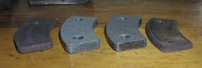 (Image: Closeup of brake pads, new vs. old)