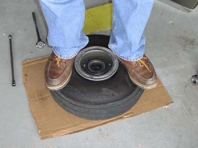 (Image: Standing on tire to break the bead seal)