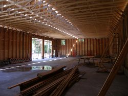 (Image: Shot of the interior of the building with the trusses exposed)