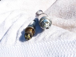 (Image: Closeup comparison between new and old plugs with 80K miles)