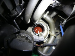 (Image: Power steering reservoir open showing old fluid)