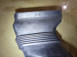 (Image: Closeup of airbox intake tube with part number)