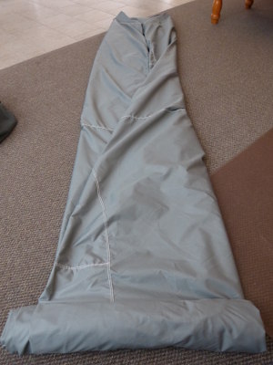 (Image: Rolling up car cover for later ease of installation)