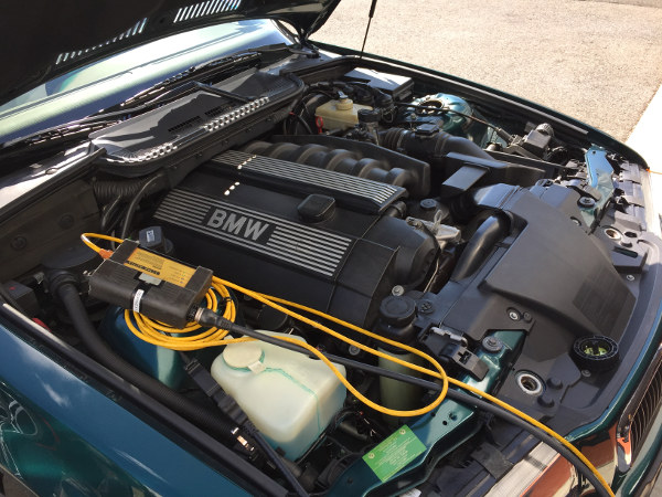 (Image: Picture of under hood with diagnostic head attached)