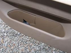 (Image: Closeup of door panel storage pocket showing damage after installation)