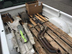 (Image: Miscellaneous drivetrain parts in back of pickup)