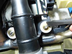 (Image: Closeup of the steering column fracture bolts showing chisel technique)
