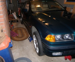 (Image: Perspective shot of E36 front end jacked up in garage for stabilizer work)