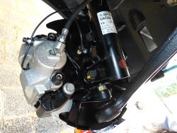(Image: Closeup of rear of left strut and brake assembly refurbished)