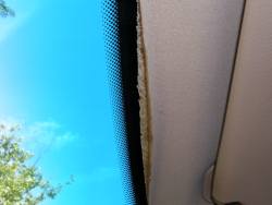 (Image: Separation of headliner fabric near windshield)