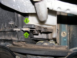 (Image: Closeup of left side crosstie cable connection and removal technique)