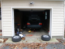 (Image: E36 in garage on jack stands with wheels removed)