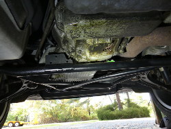 (Image: Oil and dirt on bottom of engine and transmission)