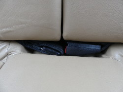 (Image: Closeup of cutout in rear seat base for seat belt receptacle)