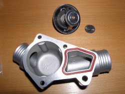 (Image: E36 metal thermostat housing and thermostat)