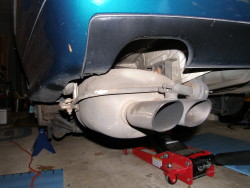 (Image: Showing muffler lowered when mounts disconnected from body)