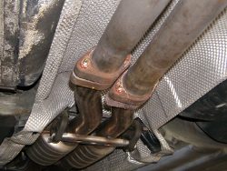 (Image: Muffler section attached to midsection with new bolts and 
	 copper nuts)