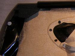 (Image: Closeup of embossed area on rear of door panel showing where to cut)