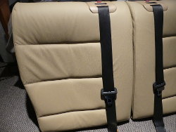(Image: Closeup of the backrest seatbelt mechanism pocket)