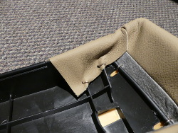 (Image: Closeup of rear bolster leather flap fastened with hog rings)