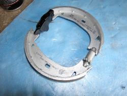 (Image: A closeup of the parking brake shoes along with expander and adjuster)