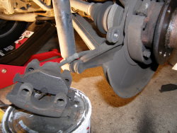 (Image: Closeup of E36 rear brake caliper removed)