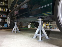 (Image: Car up on four flat top jackstands for rear brakes overhaul)