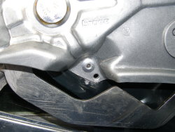 (Image: Closeup of unmodified rivet holding regulator assembly to door)