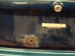 (Image: More rust on the trunk lid near license plate frame)