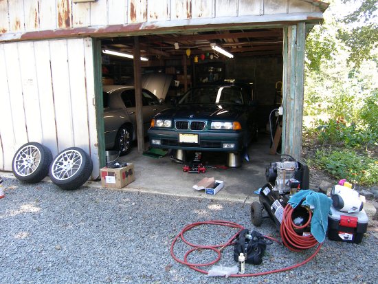 (Image: E36 in the detached garage getting front brakes installed)