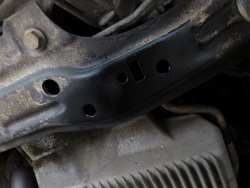 (Image: Closeup of holes drilled in subframe for xbrace)