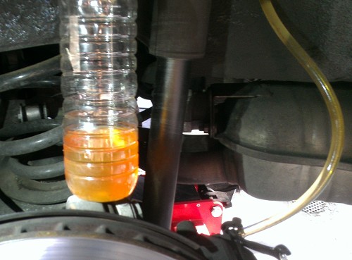 (Image: Closeup of the old fluid seen during the first DIY brake flush)
