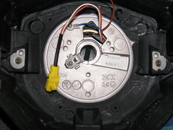 (Image: Closeup of three spoke steering wheel hub area and wiring connectors)