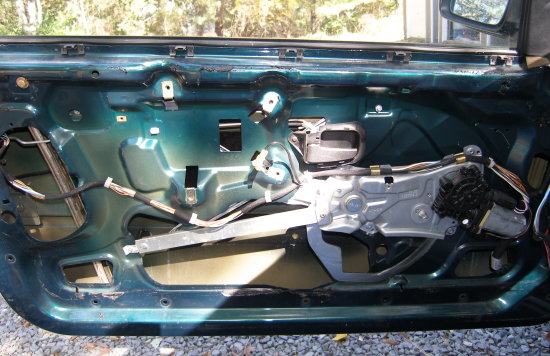(Image: Power window motor and regulator on door)