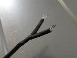 (Image: Thin thermocouple wires folded for terminal insertion)