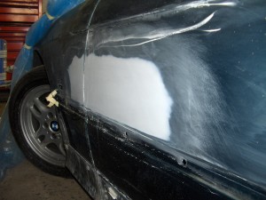 (Image: Sideswipe work in progress - closeup of driver's door and 
		    quarter panel)