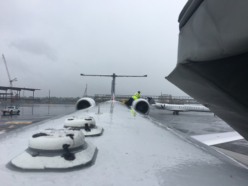 (Image: A mechanic replaces the left hand engine bleed air valve in rain)