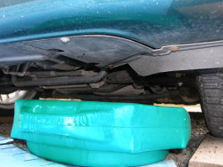 (Image: Coolant draining from radiator into waste basin)