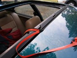 (Image: Pulling the protective tape off the sunroof seal on the fly)