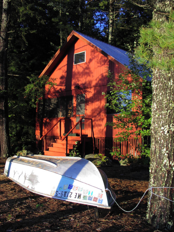 Boat in front of the Maine cabin